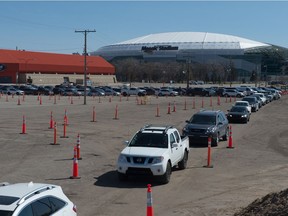 Vehicles line up for the drive-thru COVID-19 vaccine clinic at Evraz Place in Regina, Saskatchewan on May 4, 2021. Not everyone has access to drive-thru options, so alternatives, like walk-in clinics, are available.