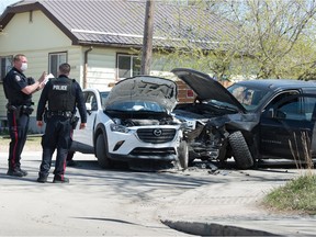 REGINA, SASK : May 7, 2021  -- Police work at the scene of a collision involving two vehicles and a pedestrian near the intersection of Rothwell Street and 9th Avenue in Regina, Saskatchewan on May 7, 2021.

BRANDON HARDER/ Regina Leader-Post