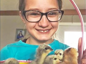 Natalie Nernberg with some chicks on her family's acreage in the RM of Longlaketon in the Craven area. (Photo supplied through Local Journalism Initiative)