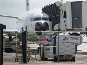 A plane sits docked to a terminal at the Regina International Airport in Regina, Saskatchewan on May 11, 2021.