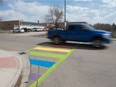 A freshly-painted, LGBTQ-themed rainbow crosswalk is seen in front of Argyle School in Regina, Saskatchewan on May 14, 2021.