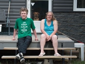 Little brother Tayler Hood and his mother Tammy sit on the front step of their home in Regina with their dog Gino. Hood matched with his big brother Emilio Di Giuseppe two years ago and they have been inseparable ever since.