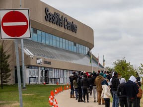 A line of people wait to receive their dose of COVID-19 vaccine at the clinic run by the Saskatoon Tribal Council at Sasktel Centre.