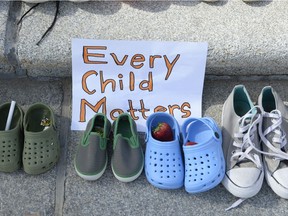 Children's shoes in a display to represent children who died while in Canada's residential school program are seen on the steps of the Saskatchewan Legislative Building in Regina on May 31, 2021.