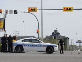 Police work on the scene of an incident involving a vehicle colliding with a pedestrian at the intersection of Victoria Avenue and Prince of Wales Drive in Regina, Saskatchewan on May 31, 2021.