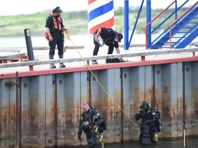 Members of the RCMP dive team search around the pier at Regina Beach, Saskatchewan on May 31, 2021. The search was part of an ongoing investigation into the Misha Pavelick case.