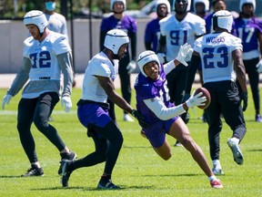 Vikings wide receiver Justin Jefferson (18) runs after the catch in drills at OTA at TCO Performance Center in Eagan, Minn., Wednesday, May 26, 2021.