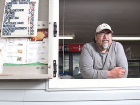 Gary (Chop) Bresch leans over the window of the concession stand at the Kiwanis Park baseball diamonds.