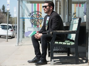 Jefferson Wourms, chair of the Cathedral Village Arts Festival, sits on 13th Avenue in Regina on May 16, 2020. The festival normally takes place along the street each year, but this year it has adopted an online format due to the COVID-19 pandemic.