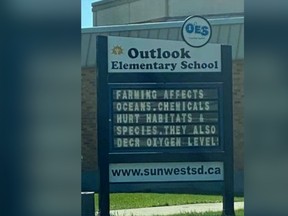 A sign outside Outlook Elementary School that criticized farming has been removed. The school division has issued an apology.
