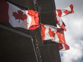 Flags fly on an apartment building near Broadway Avenue in Saskatoon to celebrate Canada Day in 2020. (Matt Smith/Saskatoon StarPhoenix).