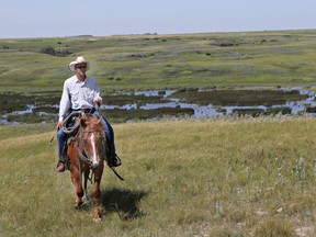 Stacy Oliver, manager of the McCraney Community Pasture, is pictured on the pasture 20 kilometres northeast of Davidson in 2014. The federal Community Pasture Program was scrapped in 2012 and management of grasslands was turned over to provincial governments. The farmers who took cows to McCraney Pasture formed a corporation, leased the land and created a contract under which they paid Oliver to continue looking after their livestock. Not all pastures were able to do the same.