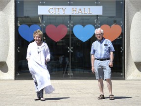 Barbara Keirnes-Young and Andre Nogue stand in front of City Hall in Regina, Saskatchewan on June 3, 2021. Both are volunteers with Age Friendly Regina, a group dedicated to advocacy for the elderly.