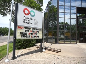 A sign outside of Canadian Blood Services on Broad Street in Regina, shows their new pandemic hours.