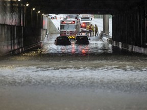 The Regina Fire & Protective Services attend to some vehicles in distress under the Broad Street underpass in Regina on June 11, 2021.