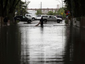REGINA, SASK :  June 11, 2021 --   Trynell Johnson tries to find and clear debris from the storm drain on the 1700 block Quebec Street in Regina.

TROY FLEECE / Regina Leader-Post