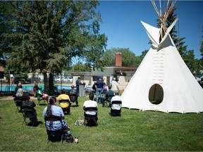 A group gathers at the newly renamed Buffalo Meadows Pool for a renaming event for both the pool and the adjacent park in Regina, Saskatchewan on June 17, 2021. The name of both the pool and park was changed to remove the name of Edgar Dewdney, who provided oversight for residential schools.