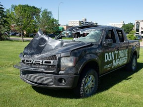 A damaged vehicle sits near the intersection of Albert Street and Gordon Road in Regina, Saskatchewan on June 17, 2021. The vehicle is part of a new MADD campaign to offer motorists a visualization of the potential outcome of impaired driving. While the truck is part of the campaign and wears a decal imploring motorists not to drive impaired, the vehicle itself was not involved in a collision where impaired driving was a factor. According to SGI, Saskatchewan police reported a total of 507 impaired driving offences in the month of May.
