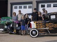 The Welta family (from left) Darlene, Ernie, Cailem, Anika, Chad, Alex, Brent, and Stacey stand beside between three of the family's hotrods, a 1928 Ford Model A sedan, a 1932 Ford 3 window coupe and a 1932 Ford pickup.