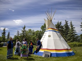 Premier Scott Moe exits a teepee at Government House.  Lt.-Gov. Russ Mirasty hosted the Saskatchewan residential schools memorial site dedication in Regina on June 21, 2021.