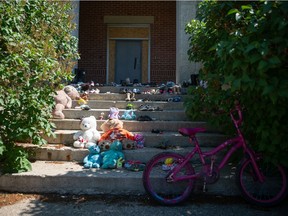Childrens toys, shoes and a bicycle sit on the steps of the former Muscowequan Indian Residential School on Muskowekwan First Nation in Saskatchewan on June 22, 2021.