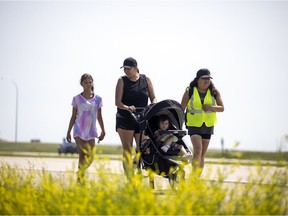 Shayna Taypotat, right, is walking to Kamloops in honour of the 215 graves found in Kamloops and the 751 found in Cowessess. Raemarie Pritchard and her two daughters Damaya, left, and Ruby joined Taypotat for part of her walk west of Regina on Tuesday, June 29, 2021.