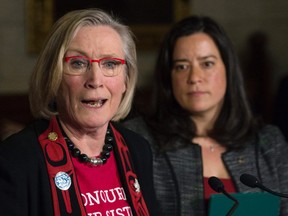 Jody Wilson-Raybould looks on as Carolyn Bennett responds to a question during an announcement for a Missing and Murdered Indigenous Women inquiry during a news conference in the Foyer of the House of Commons on Tuesday, December 8, 2015.