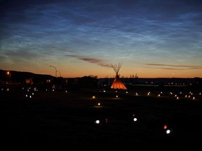 Solar lights and flags now mark the spots where 751 human remains were recently discovered in unmarked graves at the site of the former Marieval Indian Residential School on the Cowessess First Nation in Saskatchewan on June 27, 2021. - Fires on Saturday destroyed two more Catholic churches in indigenous communities in western Canada, following grim discoveries at former church-run indigenous residential schools of nearly 1,000 unmarked graves. More than 750 unmarked graves have been found near a former Catholic boarding school for indigenous children in western Canada, the second such shock discovery in less than a month.