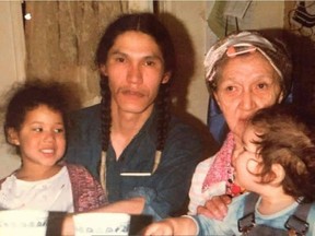 CP-Web. Eagleclaw Thom (right) sits on his grandmother's lap while his father, Bernard Bunnie, holds another child in a handout photo. Both adults in this photo attended the Marieval Indian Residential School in Saskatchewan. THE CANADIAN PRESS/HO-Eagleclaw Thom MANDATORY CREDIT ORG XMIT: RJB106