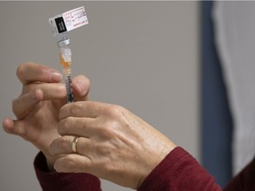 A nurse clinician prepares a syringe with the Pfizer-BioNTech COVID-19 vaccine at the Regina General Hospital in Regina on Tuesday Dec. 15, 2020.