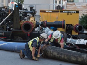 A crew works with hoses near the intersection of Broad Street and 15th Avenue as sewer relining work is underway in the area. July 15, 2019.