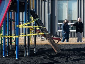 Larissa Goulet, left, speaks to Matt Jacobs playground, which was the site of a fire at Dr. L M Hanna School in Regina on Nov. 3, 2020. Goulet is a member of the school's school community council and Jacobs is a parent of children who attend the school.