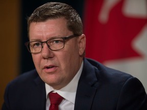 In this file photo, Premier Scott Moe speaks to members of the media during a news conference at the legislature in Regina.