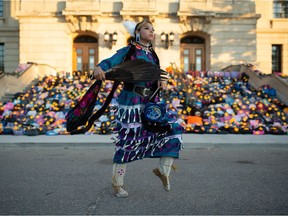 REGINA, SASK : July 1, 2021  -- Meadow Musqua performs a contemporary jingle dress routine in front of a collection of children's backpacks on the steps of the Saskatchewan Legislative Building during a vigil event, pertaining to the Cowessess and Kamloops discoveries, held there in Regina, Saskatchewan on July 1, 2021.

BRANDON HARDER/ Regina Leader-Post