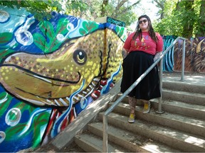 Artist Geanna Dunbar stands near her art at the entrance to the walkthrough beneath the Albert Street bridge in Regina on July 2, 2021. The art is part of what's being called the Albert Memorial Bridge Foot Tunnel Mural Project.