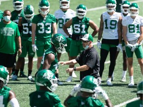 Riders head coach Craig Dickenson (centre) is beating the heat by having the team practice in the mornings.