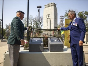 Retired army major Brad Hrycyna, left, and Saskatchewan Lieutenant Governor Russ Mirasty unveil two plaques at the Regina Cenotaph in Victoria Park honouring the veterans of The Korean War as well as on Second World War's D-Day on Tuesday, July 27, 2021 in Regina. This project has been organized by the Royal United Services Institute of Regina.