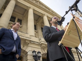 Ryan Meili, right, addresses the media on the steps of the Legislative Building on Thursday, July 29, 2021 in Regina. To the left is Regina NDP MLA Trent Wotherspoon.