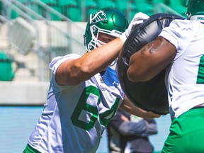 Saskatchewan Roughriders' offensive lineman Evan Johnson, left, will be absent from training camp while attending to the birth of a child.