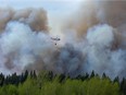 Water droppers battle an out of control forest fire after the city of Prince Albert declared a state of emergency over a fast-moving wildfire, prompting some residents to evacuate, in Prince Albert, Saskatchewan, Canada May 18, 2021. REUTERS/David Stobbe
