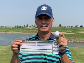 The Royal Regina Golf Club's James Tsakas shows off his golf ball and scorecard on Tuesday after registering a hole-in-one in Round 1 of the Saskatchewan senior men's golf championship at the Legends Golf Course in Warman.