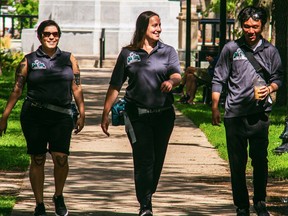 Alejandra Cabrera (left), Alyssa Marinos (centre) and Alex Lien, members of the Regina Downtown Business Improvement District's Community Support Team, walk through downtown Regina.