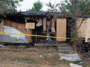 A fire-damaged home is seen behind a tape line on the 600 block of Garnet Street in Regina, Saskatchewan on August 3, 2021.