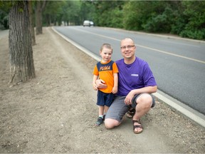Shawn Weimer of Run Regina and his son Lucan Weimer are pictured on the side of Lakeshore Drive in Regina on August 3, 2021. Weimer is among those involved in helping the Provincial Capital Commission to run a pilot project that would see the street shut down from Legislative Drive to Old Broad Street to vehicle traffic on select days to provide more room for cyclists and runners.
