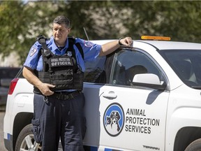 Animal Protection Officer Jason Crossley stands next to one of their service vehicles at the Regina Humane Society on Thursday, August 12, 2021 in Regina.