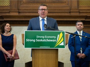 Saskatchewan Premier Scott Moe, centre, speaks to media regarding investment into a Jansen, Saskatchewan potash mine during a news conference held at the Saskatchewan Legislative Building in Regina, Saskatchewan on August 17, 2021. On frame left is Saskatchewan Minister of Energy and Resources Bronwyn Eyre. On frame right is Saskatchewan Minister of Trade and Export Development Jeremy Harrison.