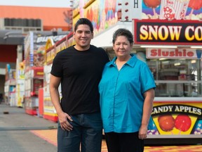 Mick Favel, left, and his mother Sandra Favel stand in front of some food stands on the grounds of the Queen City Ex as it gets set to return to Regina.