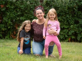 Cecilia Prokop, centre, with her daughters Elizabeth Prokop, left, and Evelyn Prokop are seen in a photo taken in Regina, Saskatchewan on Aug. 23, 2021. Cecilia is relieved that there will be a mask mandate for students where her daughters will be attending school.