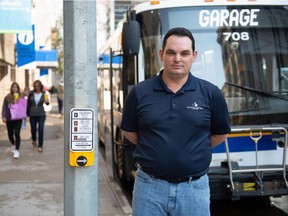 Kevin Lucier, president of Amalgamated Transit Union Local 588, stands in front of a Regina city transit bus in downtown Regina on August 27, 2021.