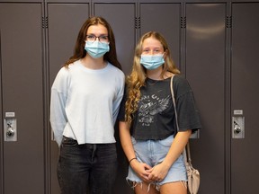 Megan Donnelly, left, and Hannah Foord stand in a hallway at the University of Regina in Regina, Saskatchewan on August 30, 2021. The university is set to resume in person classes following a stoppage due to the COVID-19 pandemic.